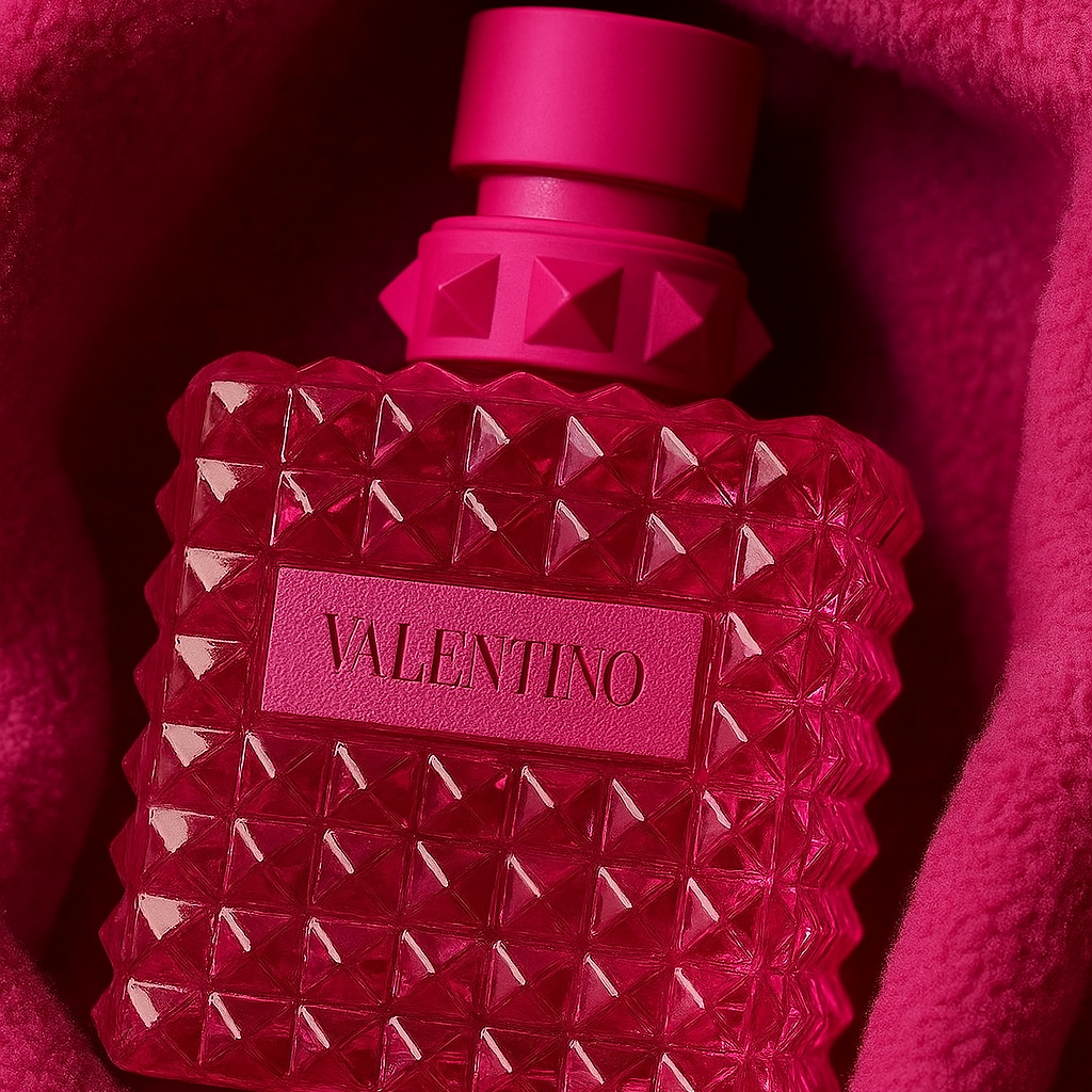 Valentino perfume bottle with pink cap and geometric design on a pink background