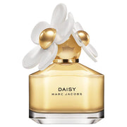 Gold Marc Jacobs Daisy perfume bottle with white flowers on a white background