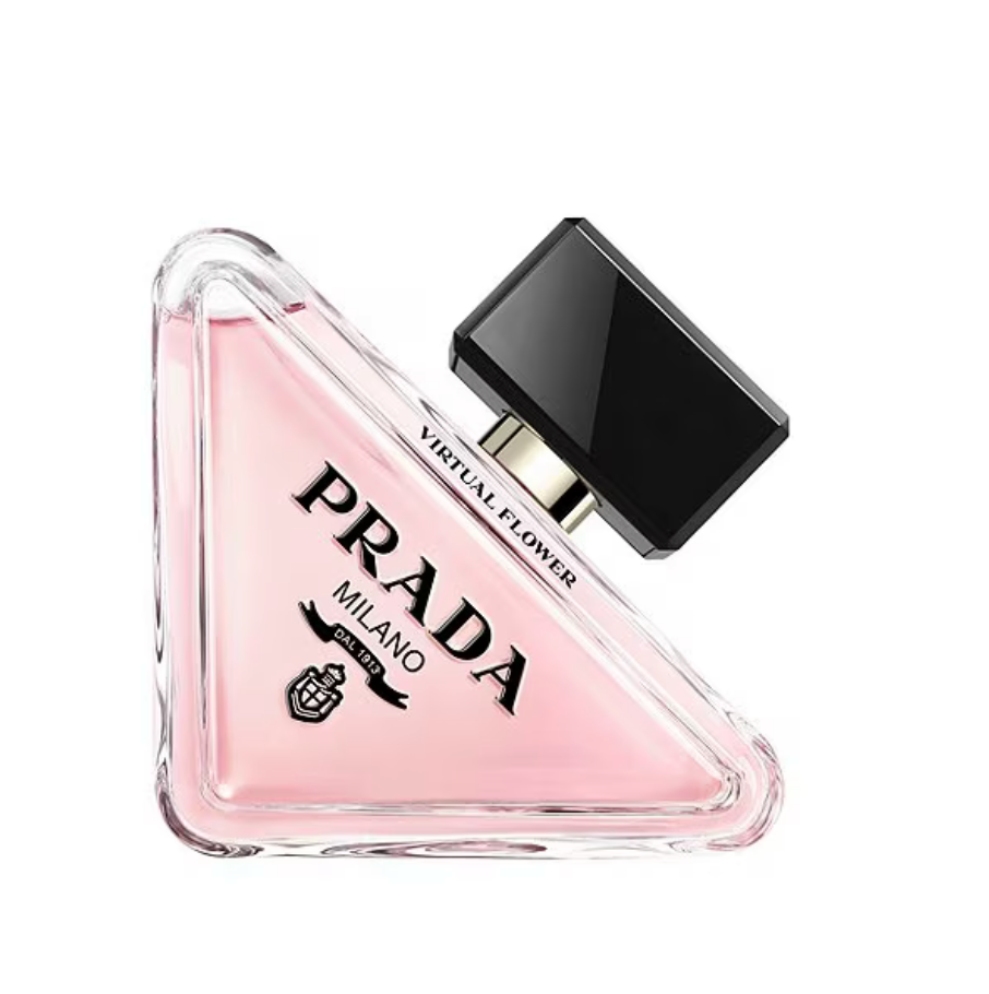 Prada perfume bottle with pink triangle shape and black cap on a white background